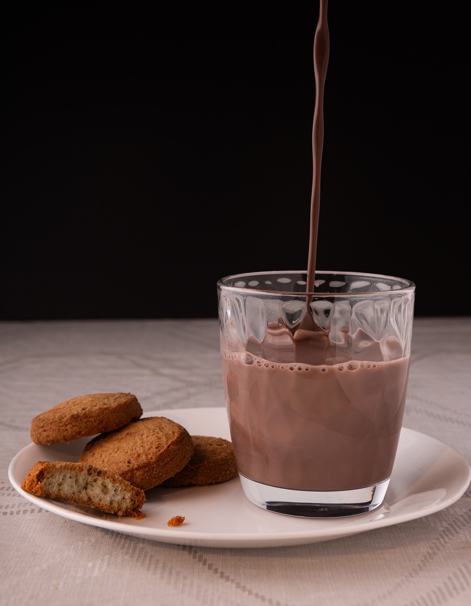 Chocolate milk falling on the glass